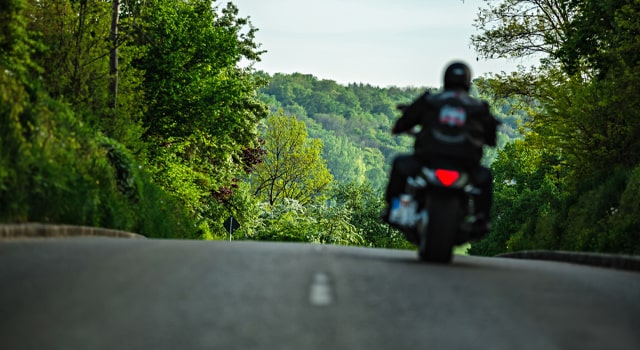 Motorcycle on open wooded road