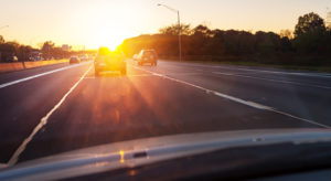 Driving down road with sun glare