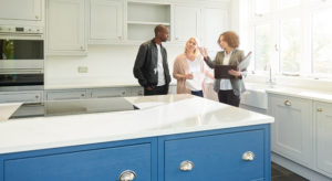 Couple speaking with realtor in a new home