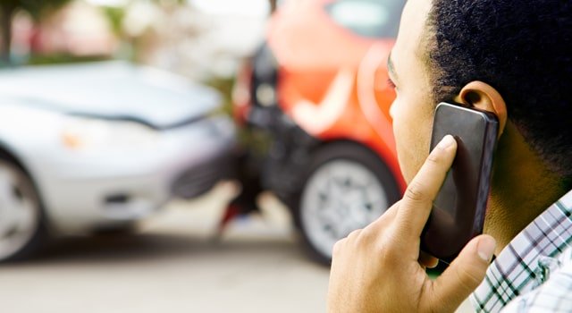 Man on phone in front of accident