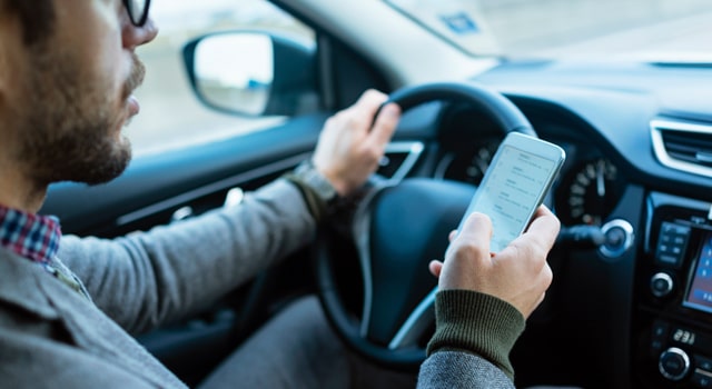 man texting driving phone dangerous