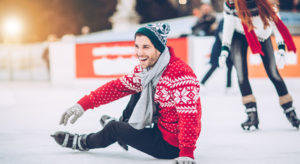 man sitting on ice in ice rink