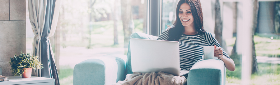 woman couch laptop happy