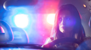 Police lights in rear window of car