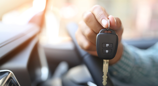 Hand holding car keys