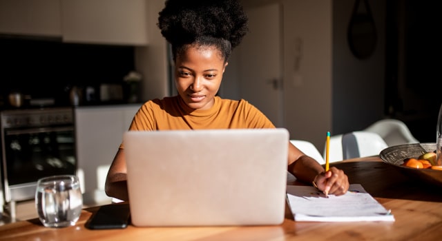 Woman reading about ct car insurance requirements on laptop