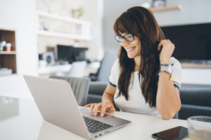 Woman on laptop figuring out what to know about home insurance