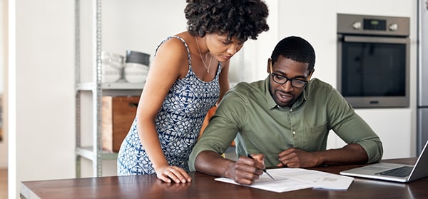 couple reviewing documents at a desk