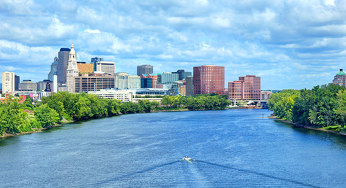 A boat in the river looking at the city skyline