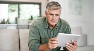 Homeowner looking at homeowners policy on a tablet