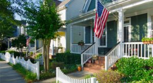 Colonial blue and white home with American flag in Massachusetts