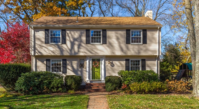 Two story beige house in New Hampshire