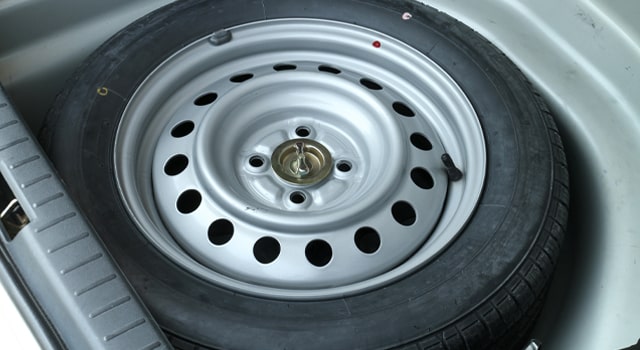 A spare tire stored away when it is not needed.