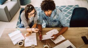 Young couple researching and comparing how much is car insurance in NJ