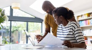 Young couple figuring out how much is car insurance in CT