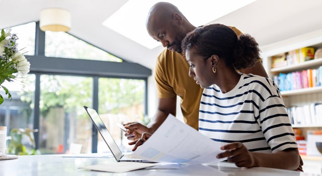 Young couple figuring out how much is car insurance in MA