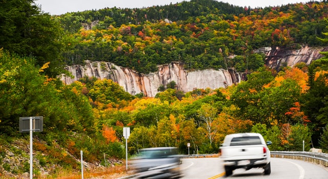 Cars driving in New Hampshire that are protected with car insurance.