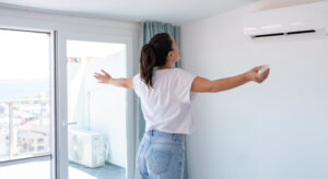 Woman standing in front of air conditioner
