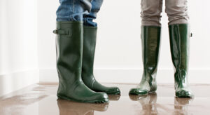 Two people standing in a flooded room