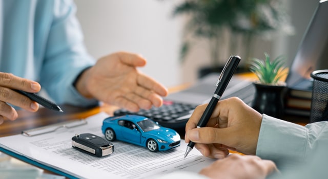 Car leasing agent going over insurance requirements with customer