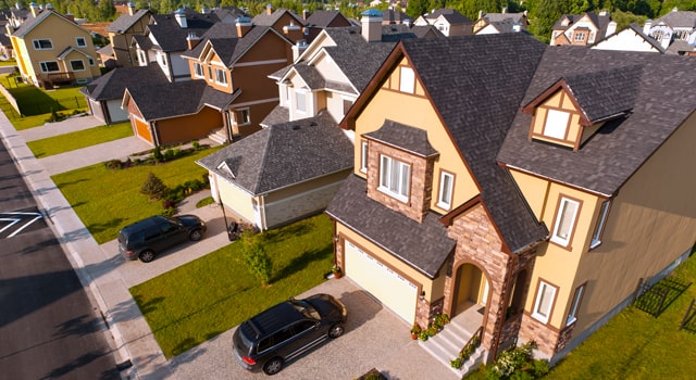 Car parked outside house in neighborhood.