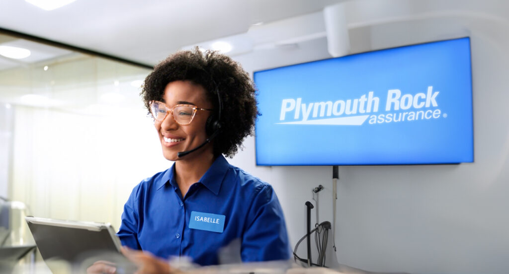 Photo of a Plymouth Rock employee named Isabelle wearing a headset and smiling