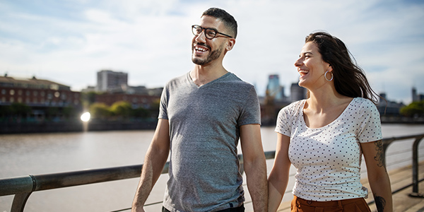 A man and woman walking along the water in New Jersey