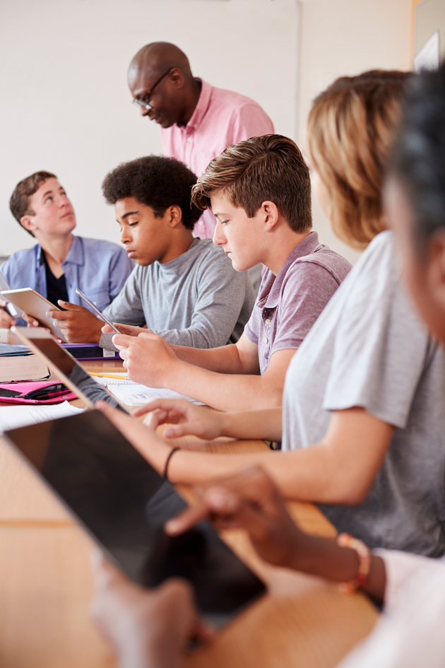 Photo of a group of students looking at tablets