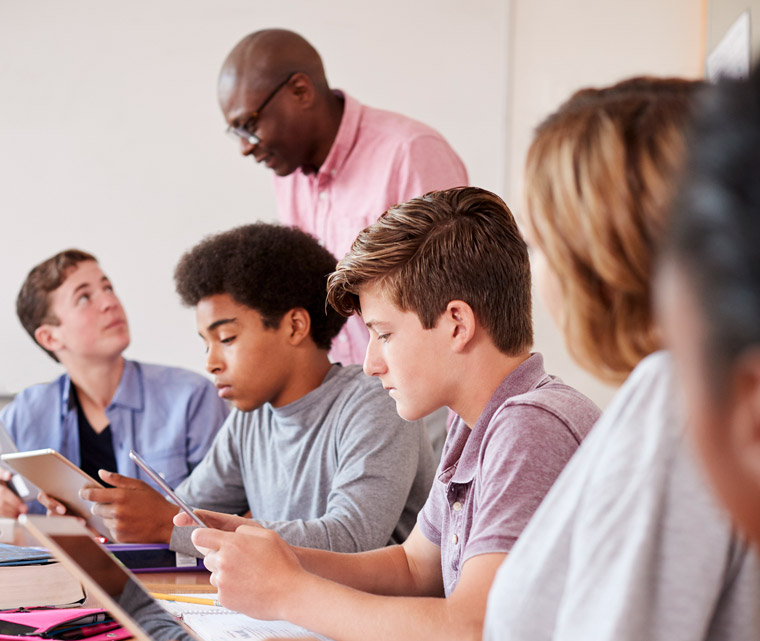 Photo of a group of students looking at tablets