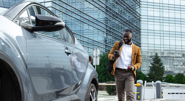 Businessman approaching his company car