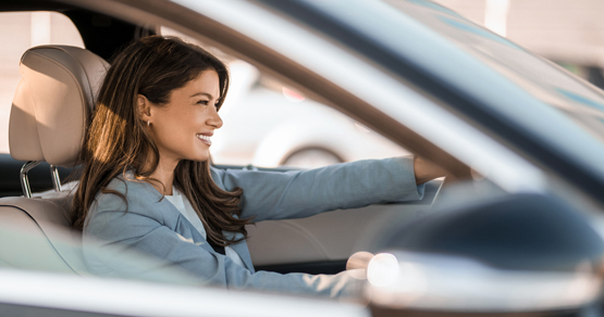 Close up of young woman driving