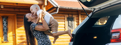 young mom with child near suv