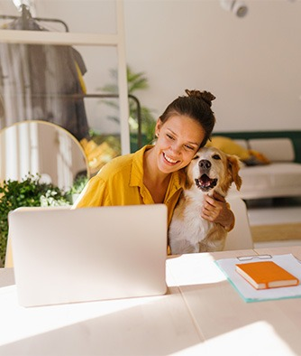 Woman and dog looking at laptop