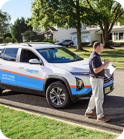 Car adjuster in front of Plymouth Rock comp[any vehicle