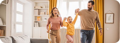 A happy family with a child in a sunny living room